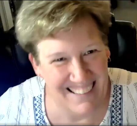 Ann Wierbinski smiling during a lampwork demonstration